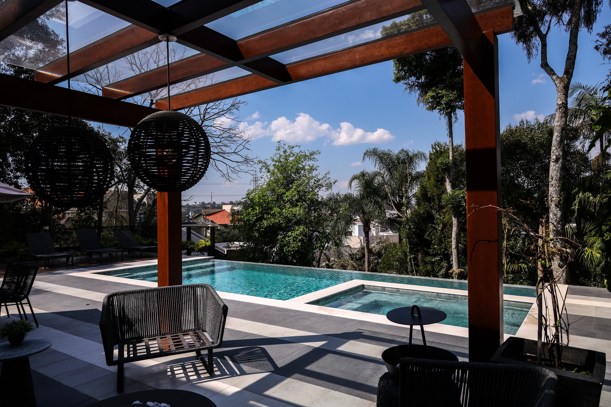 Piscina com pergolado e área de convivência